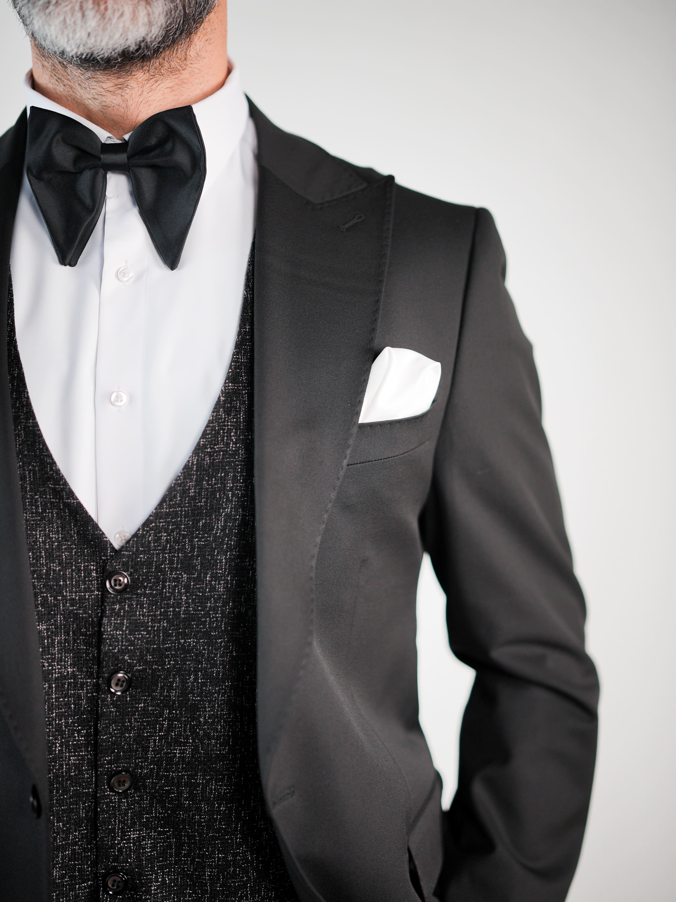 Charcoal coat paired with a refined classic suit