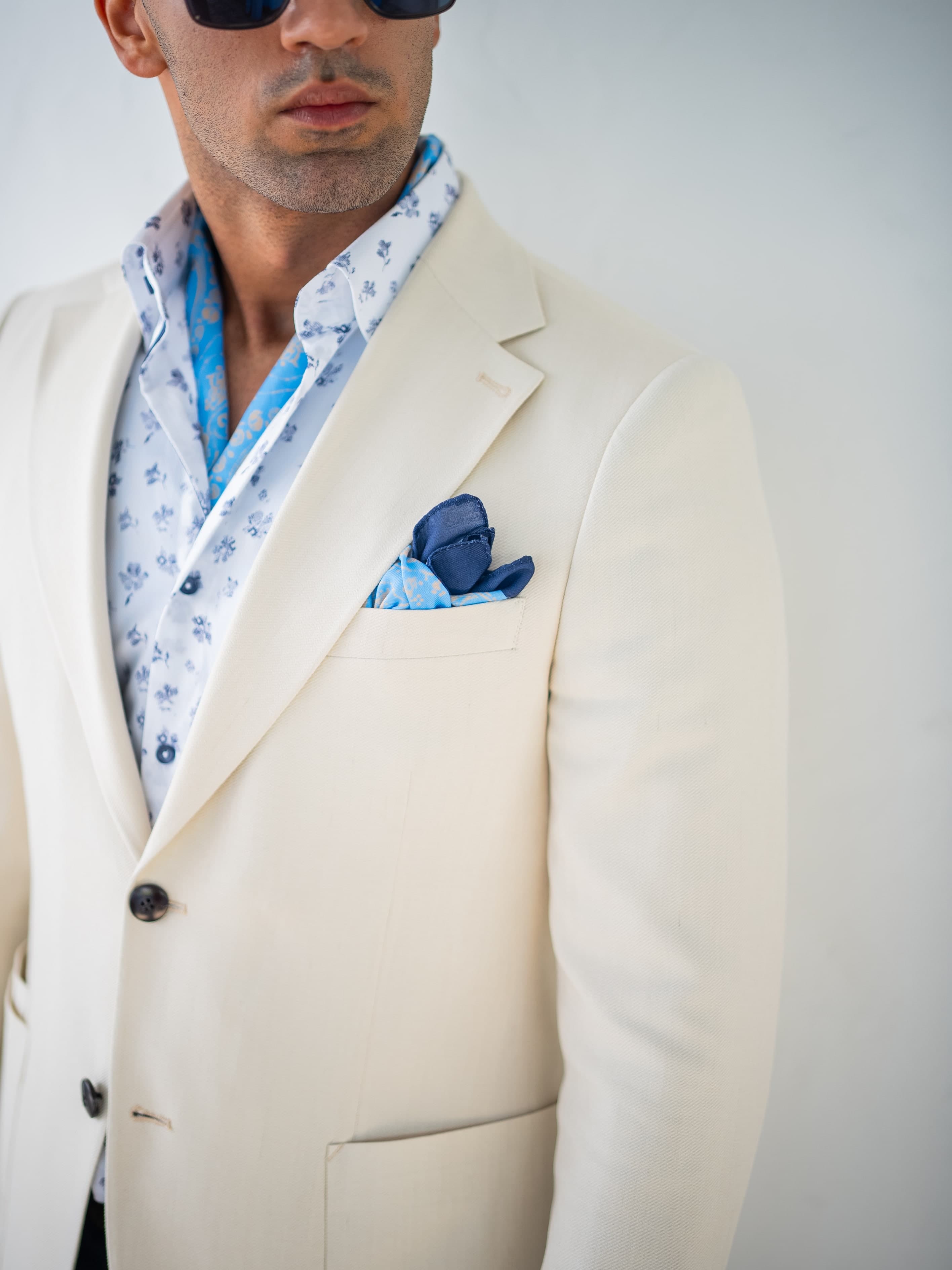 Beige overcoat layered over classic formalwear